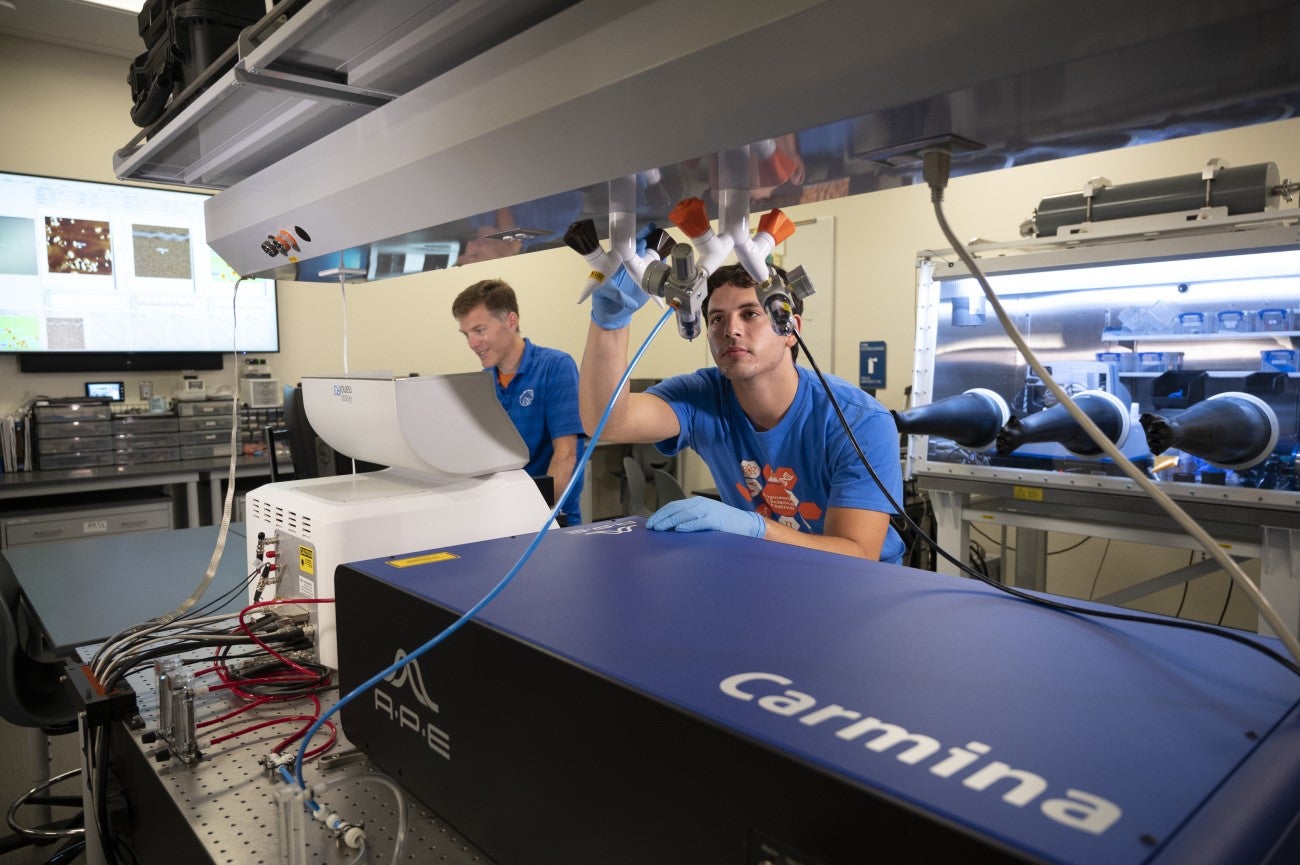 Researchers working with equipment in lab