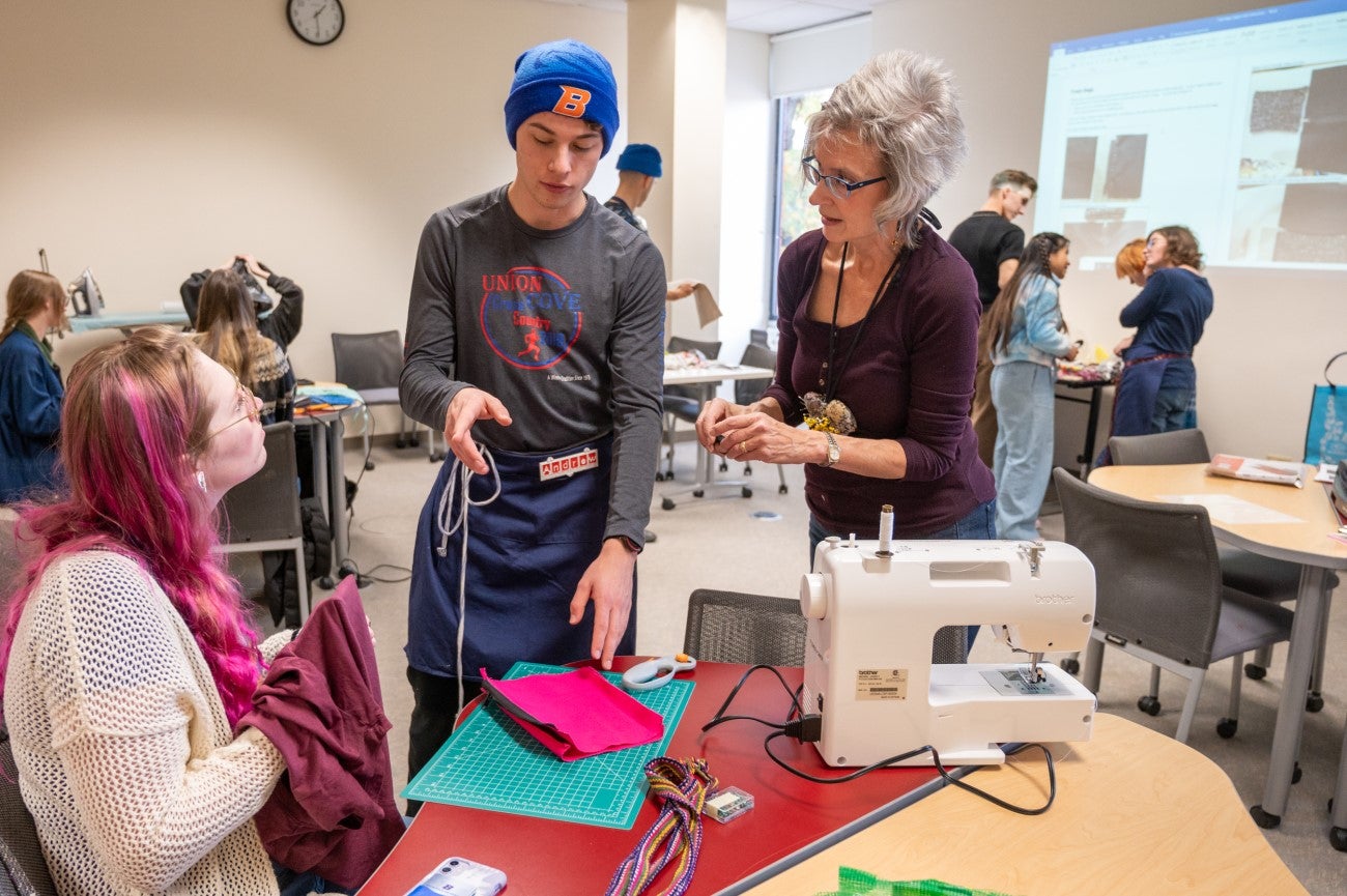 Shaun Muscolo and students working with fabrics