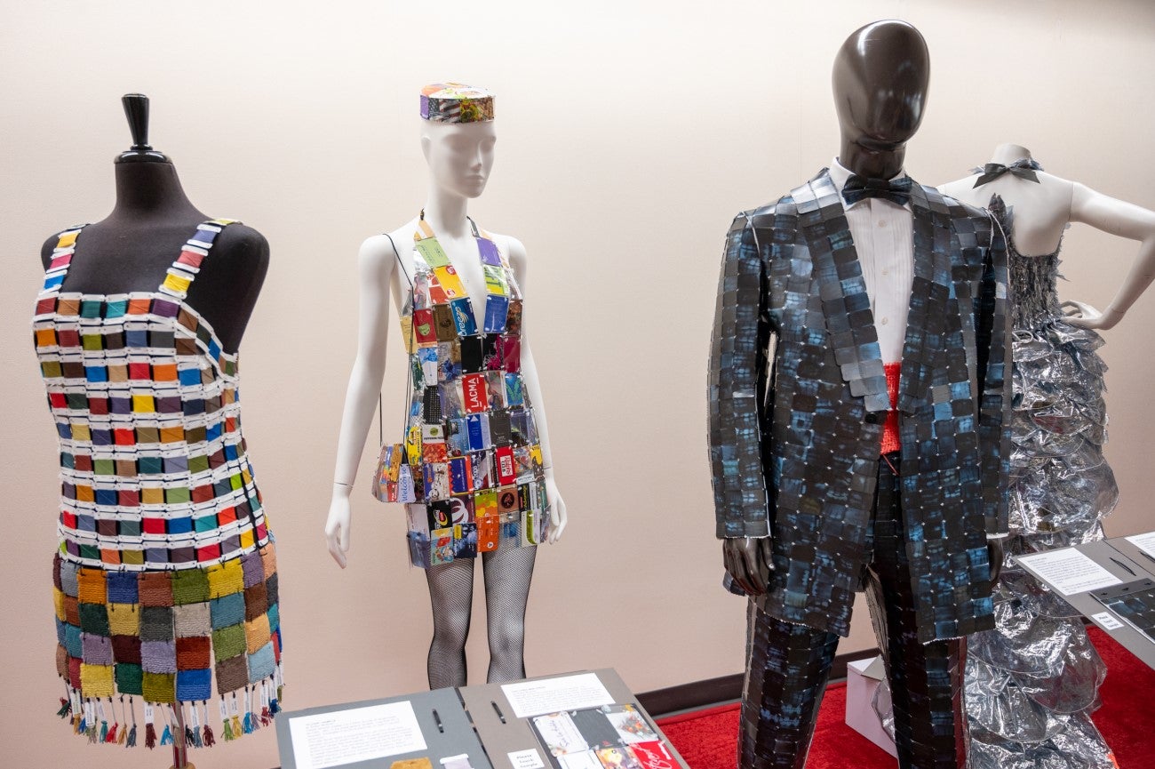 Mannequins wearing formal wear made out of recycled materials.