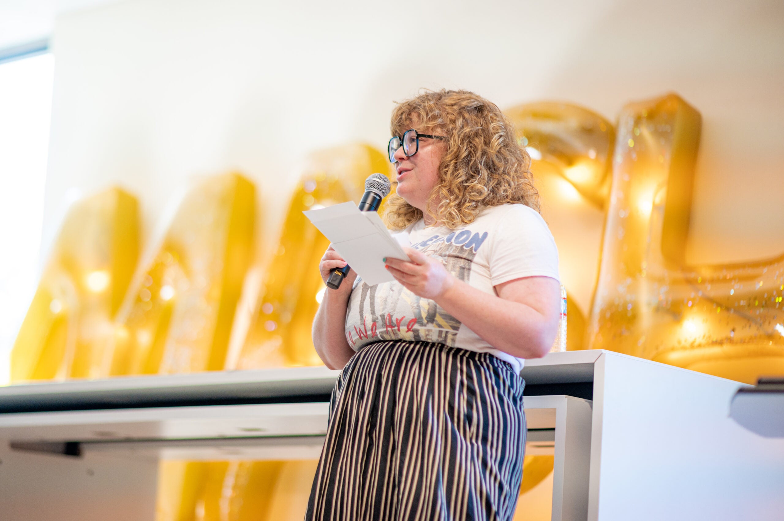 Elizabeth Kidd speaks in front of an audience at the "MashUp: Little Lectures for an Odd World” event