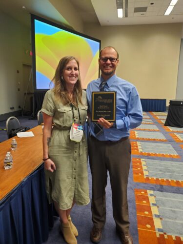 Eric Martin (right) poses with Megan Byrd, the Program Chair of Division 47.