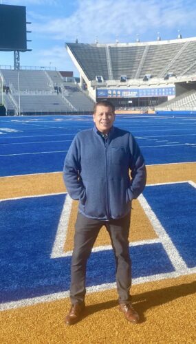 A person poses on Boise State football field