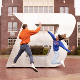 Students jump and high-five