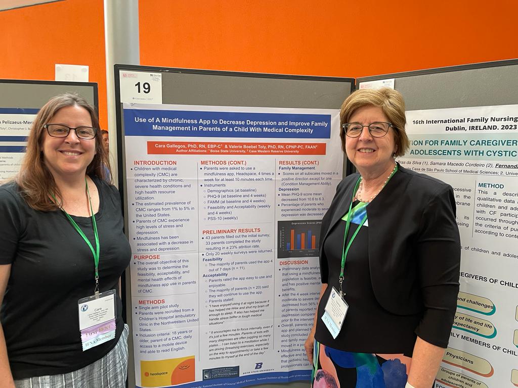 Gallegos and her mentor smile in front of their research poster.