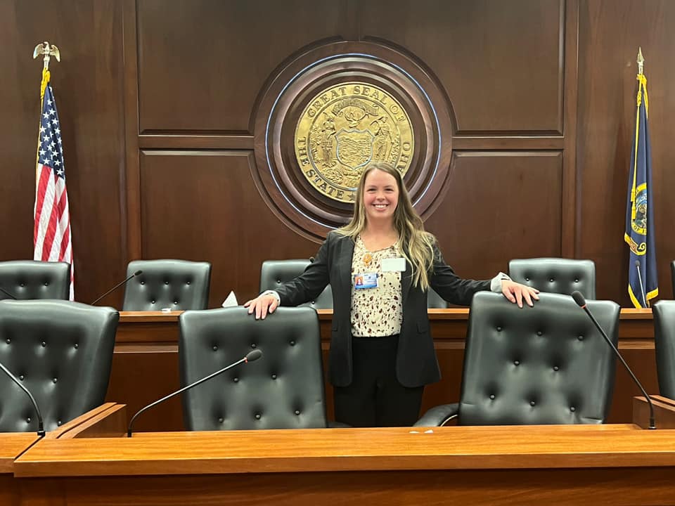 Brittany Braislin stands by the seal of Idaho in the state Capitol.