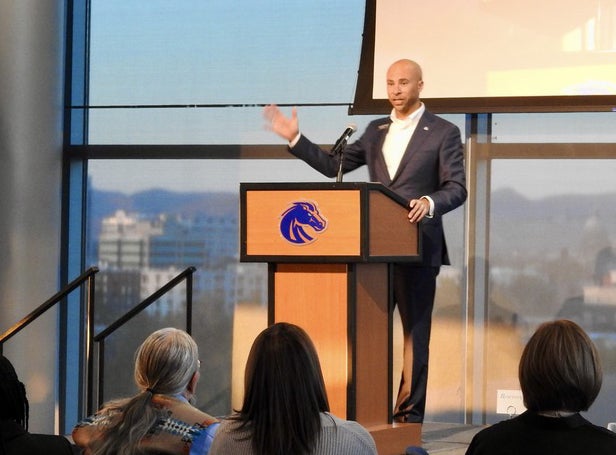 Chris Mathias at a podium speaking at the McNair 20th anniversary celebration