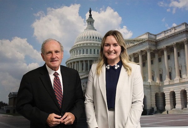 Kaelee stands next to senator in front of senate house DC