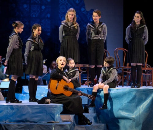 group of people on stage singing in Sound of Music