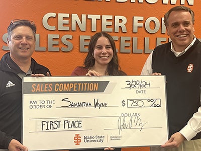 Samantha Wyne holding a big check for $750 1st place prize in role play