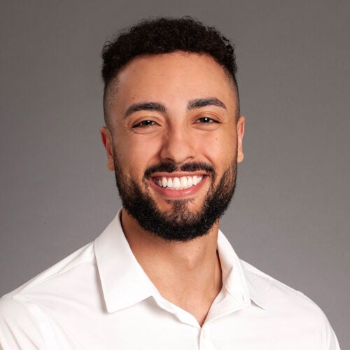 headshot of Sevio, young man wearing white polo