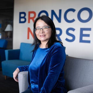 Headshot of Lucy Zhao sitting in a chair