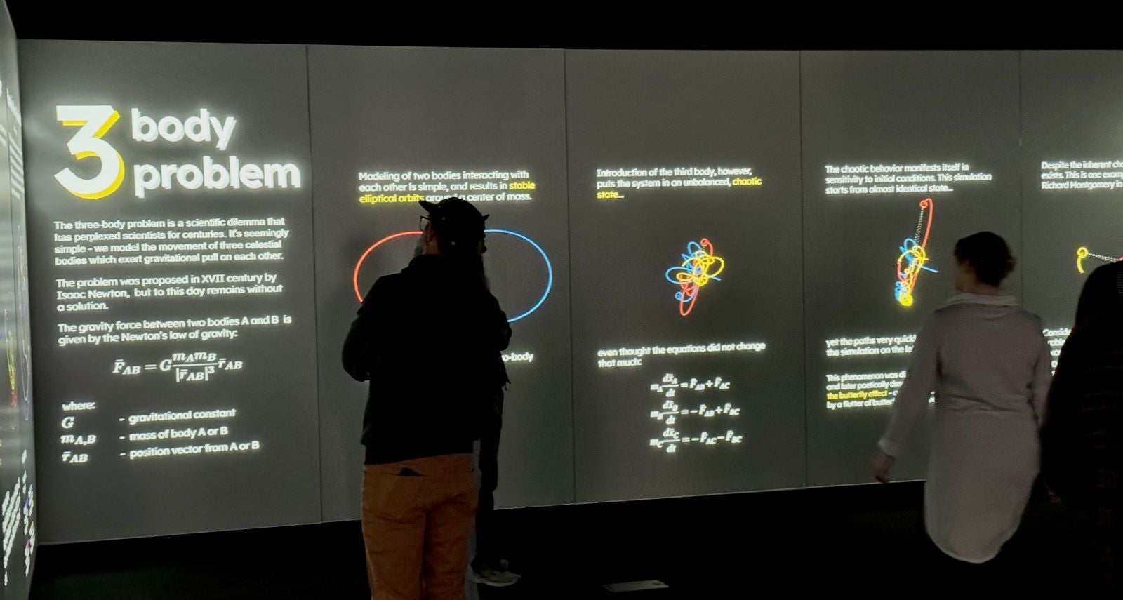 Community members experience the three-body problem exhibit