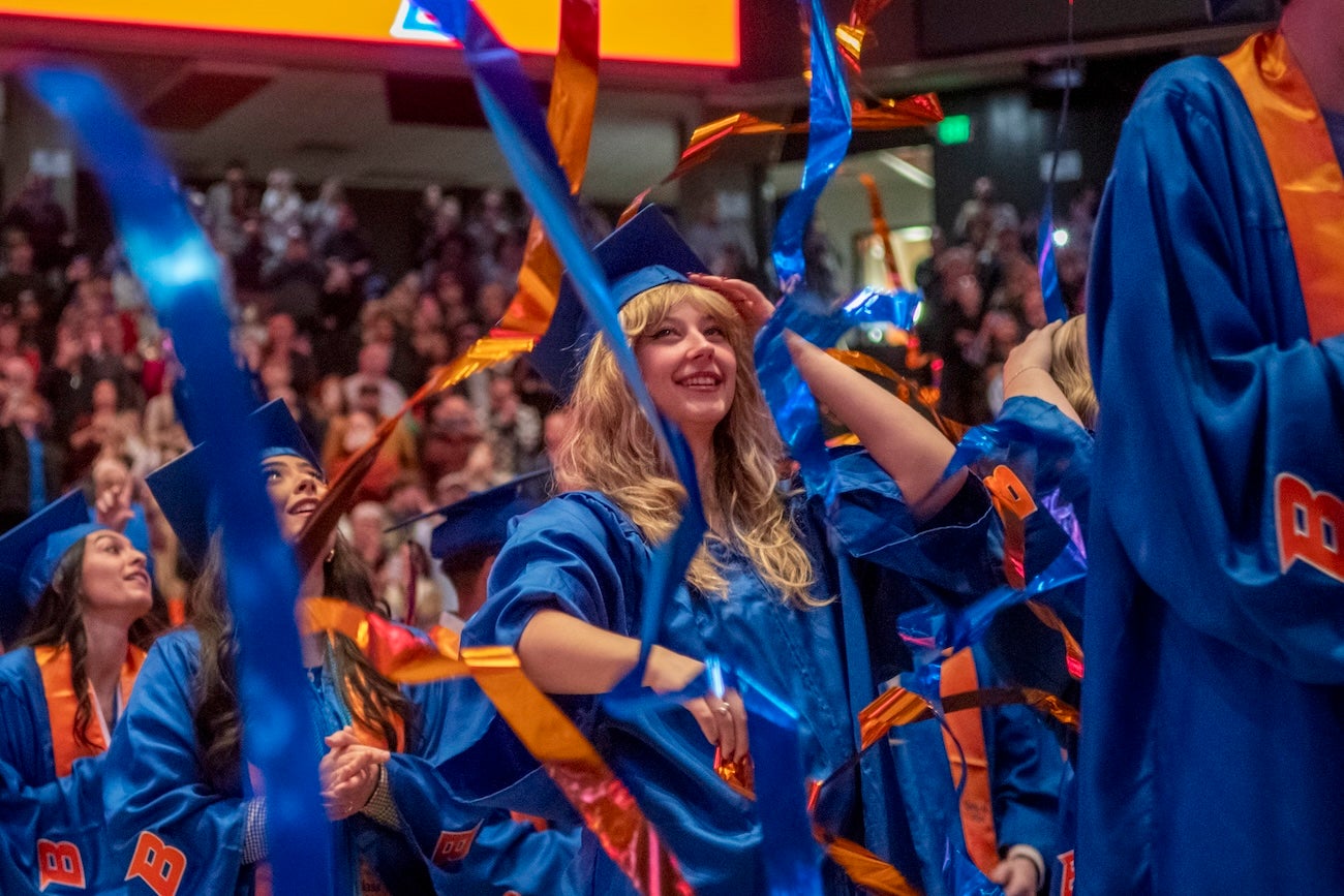 Streamers fall and graduates celebrate