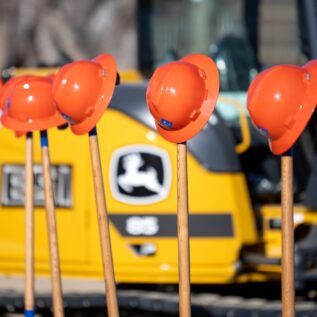 hard hats on shovels