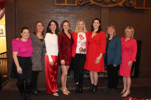 A group of persons pose at an event