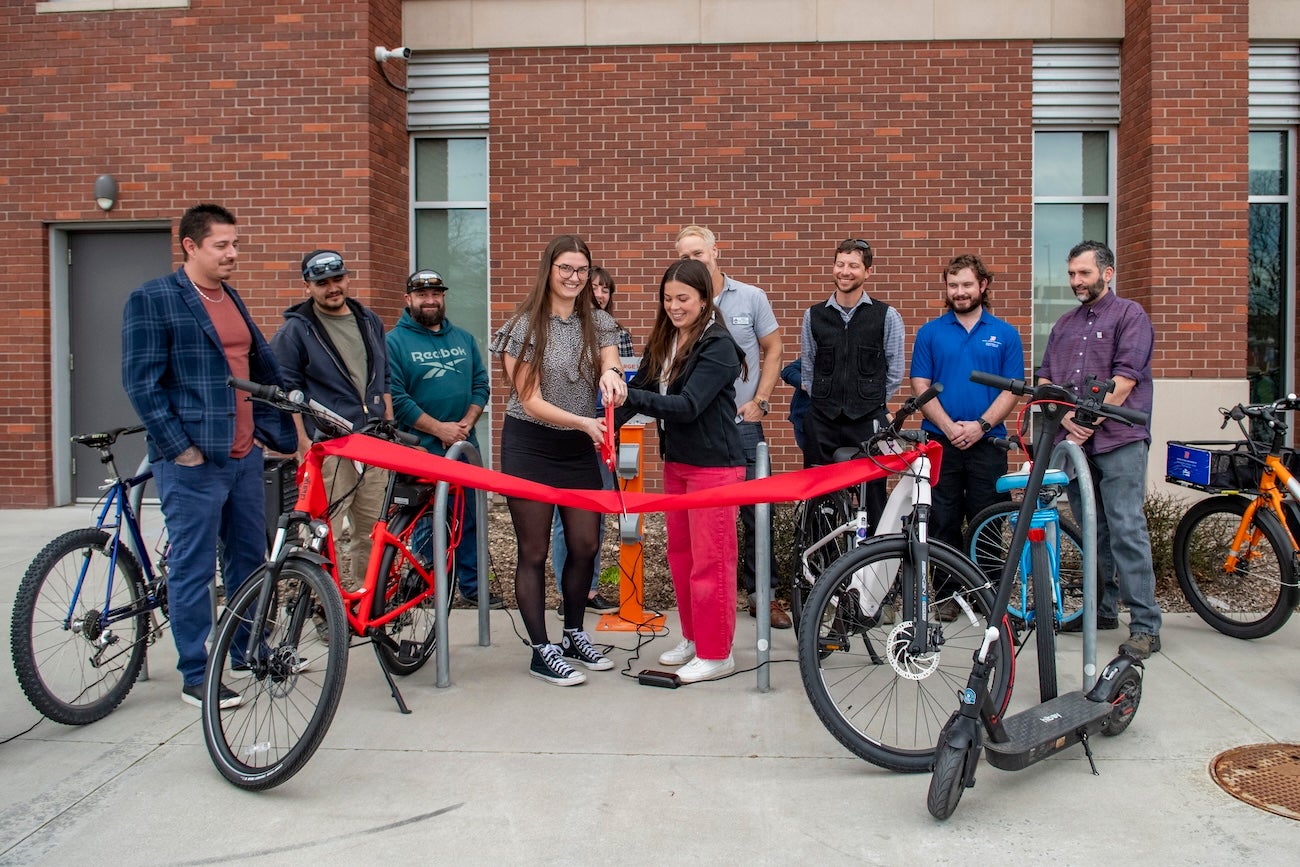 A group of persons at a ceremonial ribbon cutting