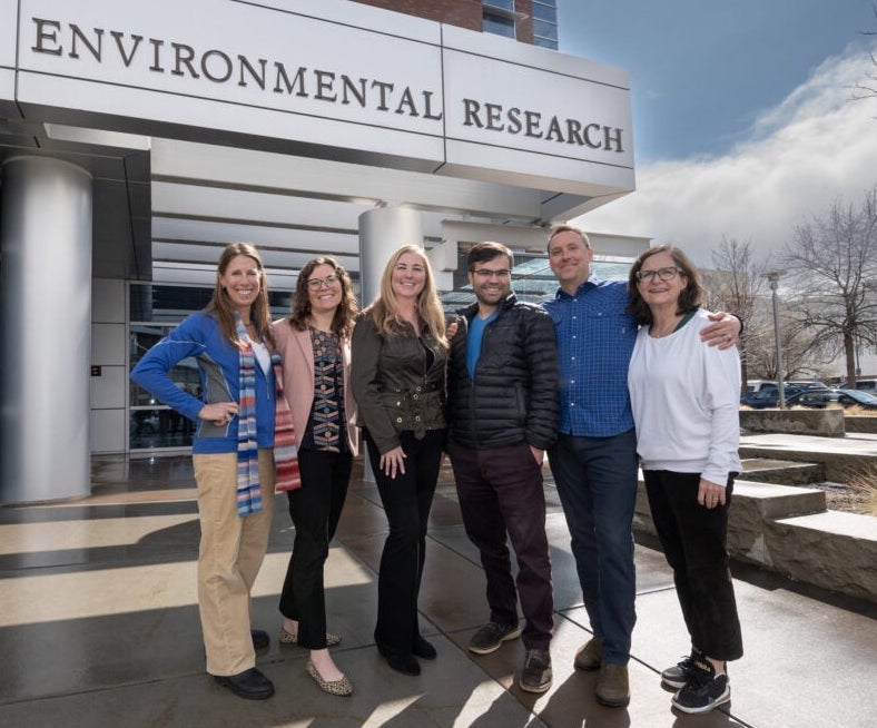 Persons pose in front of the Environmental Research Building 