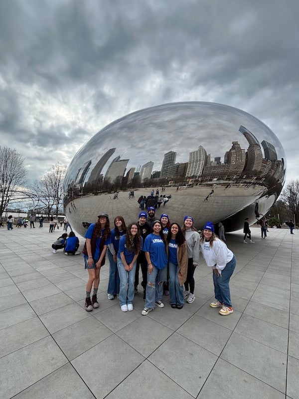Students pose in front of 'the bean' in Chicago