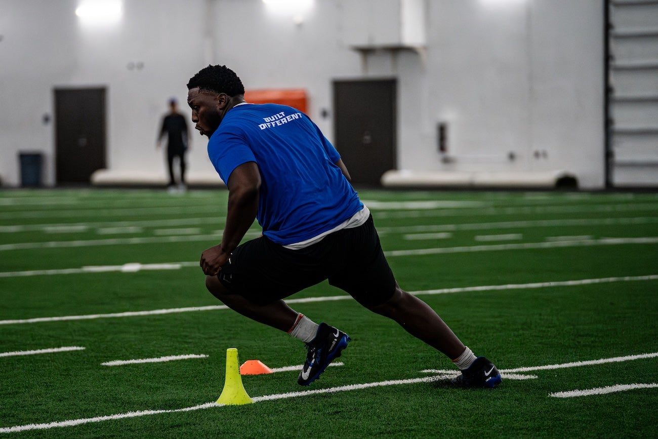 A player practices football indoors