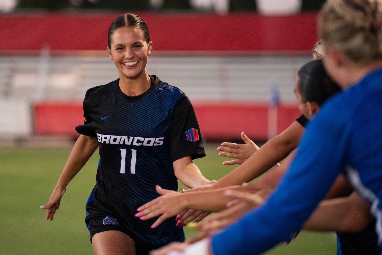 A soccer player high fives fans