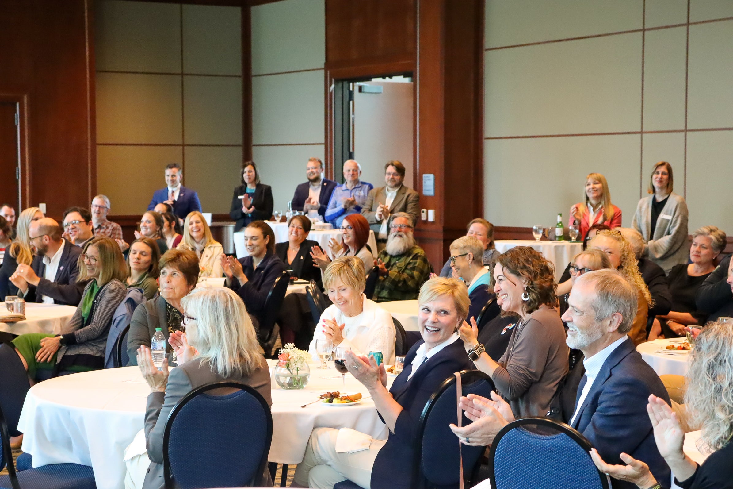 People applaud in a ballroom