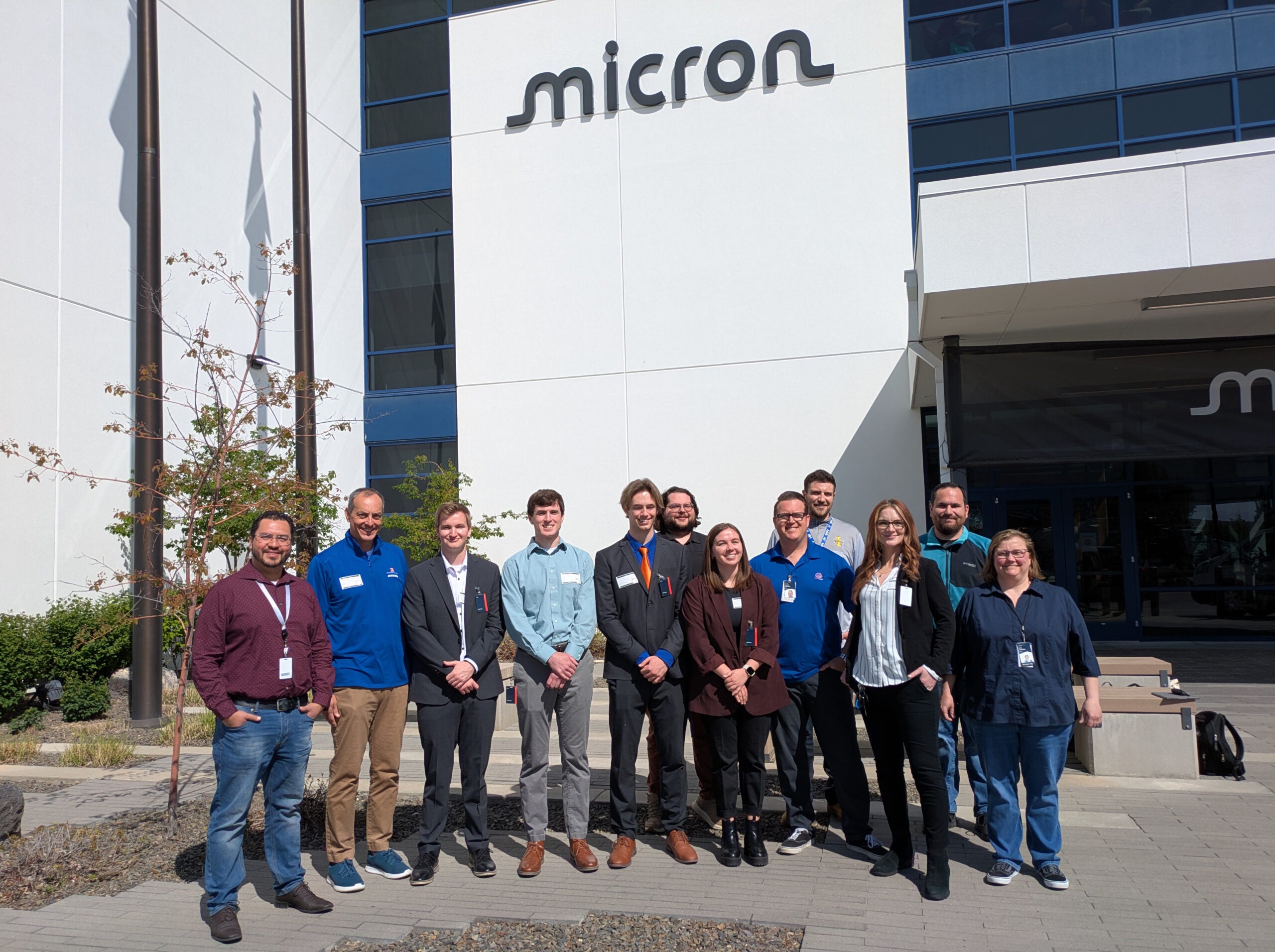 People pose outside the Micron headquarters