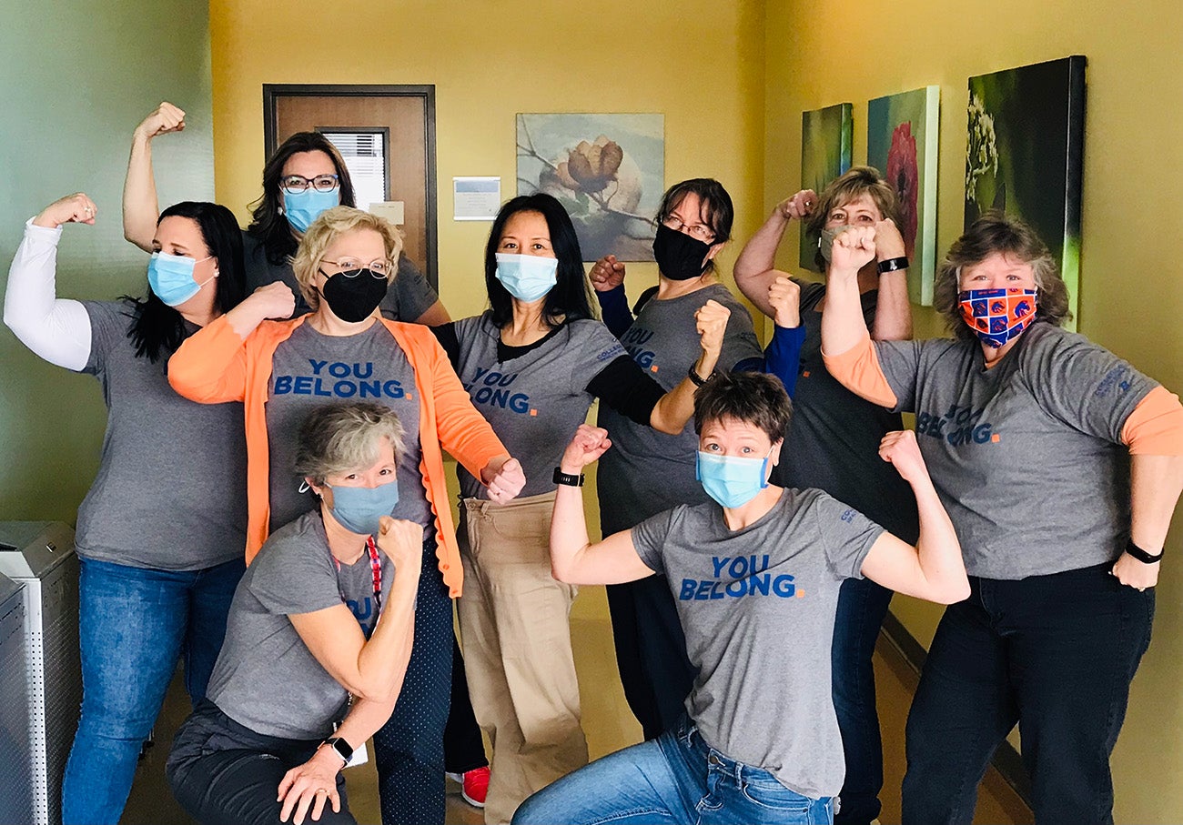School of Nursing staff gather in power poses wearing shirts that say "You Belong."