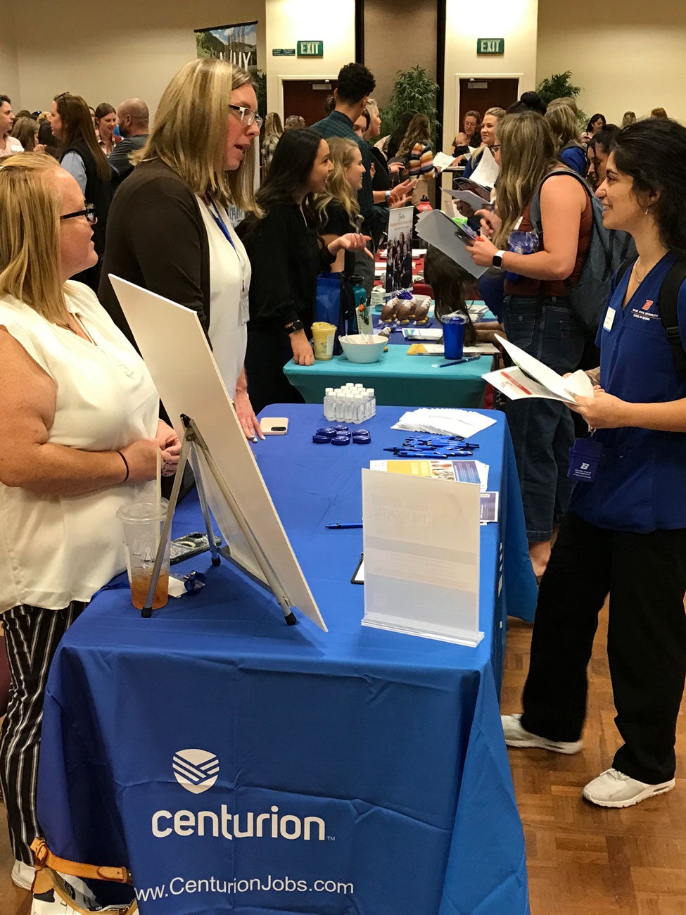 A student talks to representative at a Centurion table.