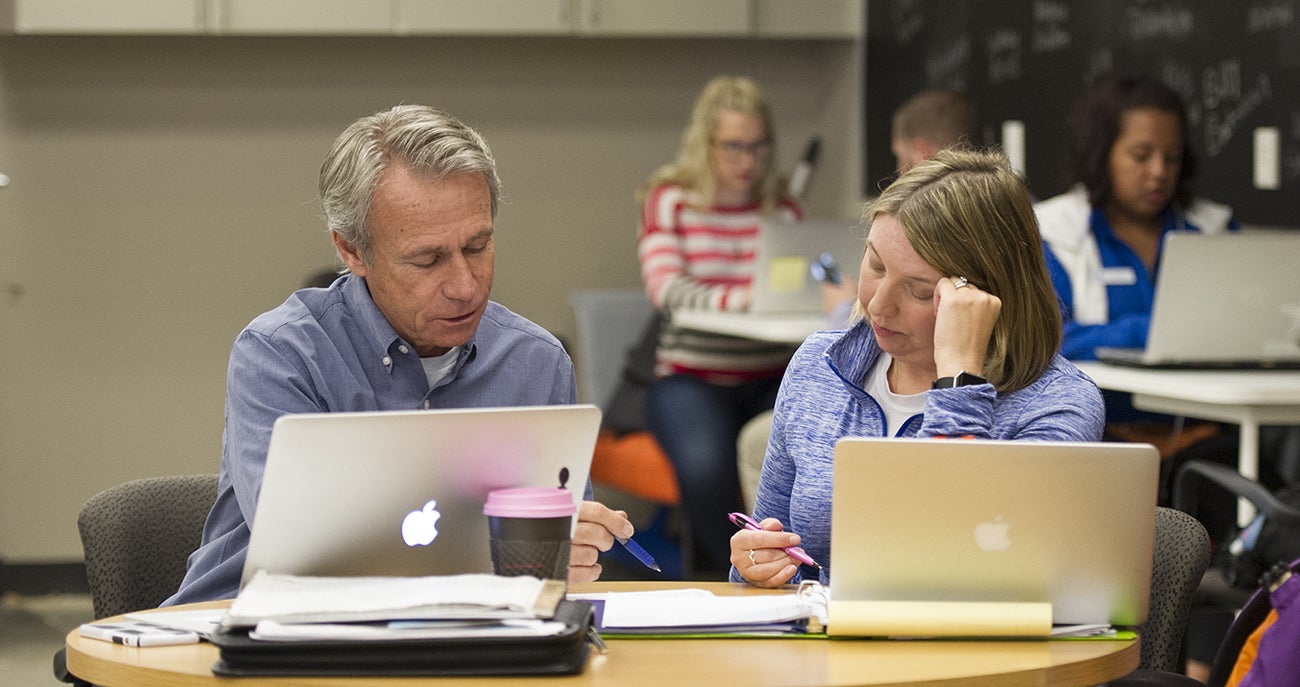Boise State student and staff member going over a document