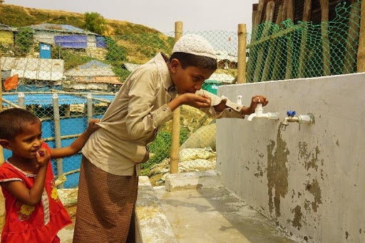 Children drinking clean water in a Rohingya camp