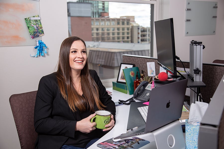 Sophia Hartsock sits at her desk at Red Sky.