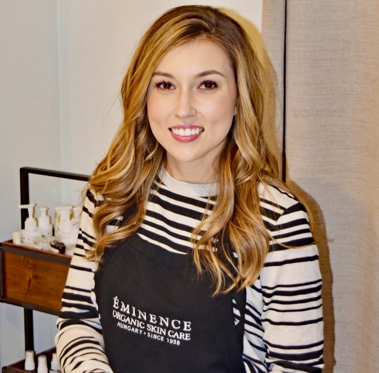 Jessika Wass smiles with her workplace apron on.