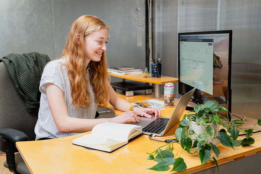 Clara Adams works at a desk and types on the computer at Oliver Russel, her place of employment.