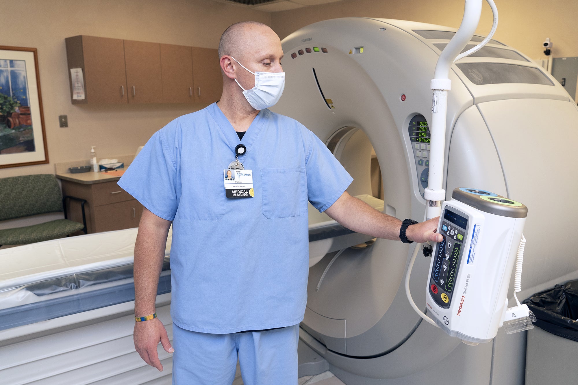 Imaging professional examines machine.