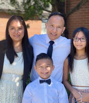 Lou ONeil Go poses with his wife and children 