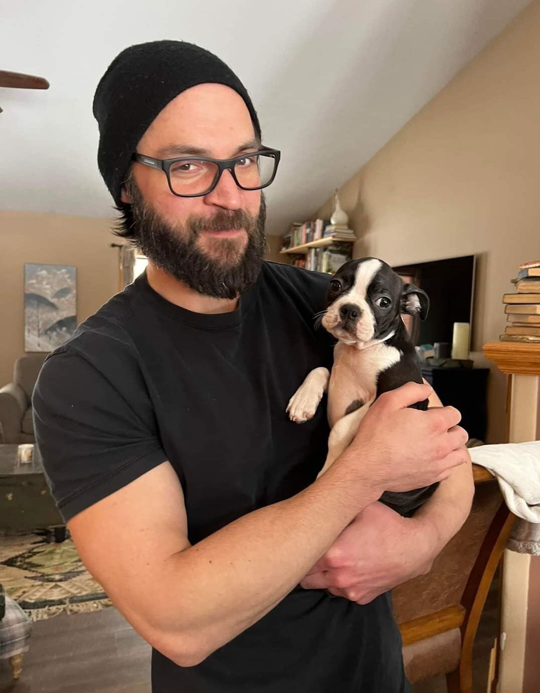 Michael Graham holds a dog and smiles.