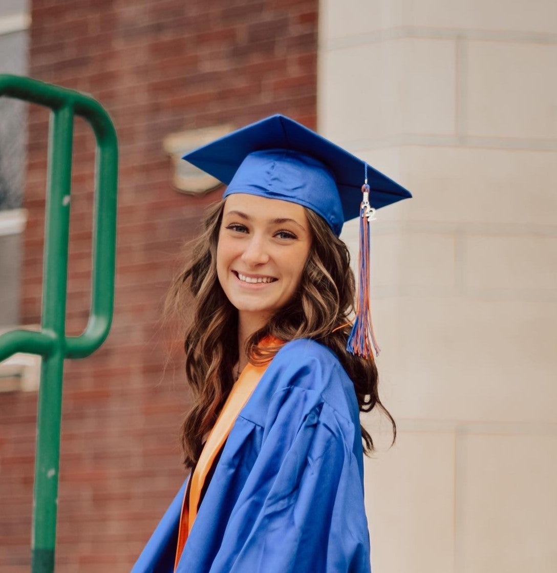 Madilyn Bosselmann in a blue cap and gown.