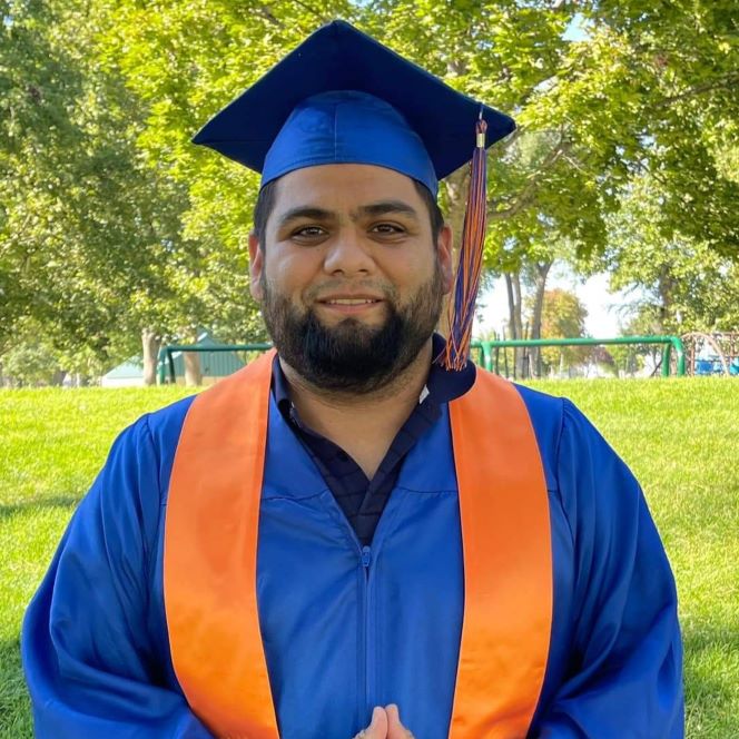 Portrait of Octavio Sarmiento wearing a Boise State graduation cap and gown