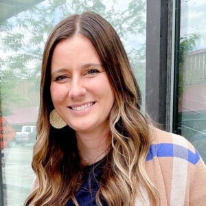 Kayla Jamison poses for a photo outside a building