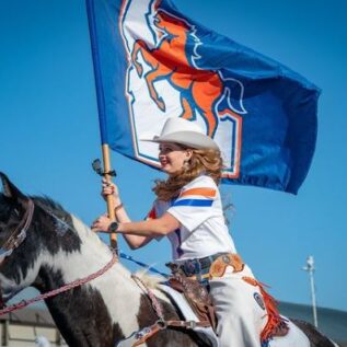 Public health graduate Cathy Jo Ayotte riding a horse