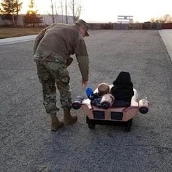 Josiah Mott in his army uniform playing with his two children