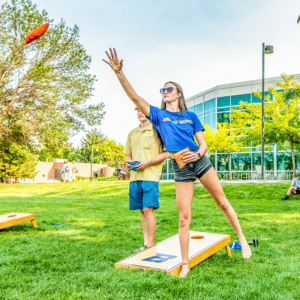 Students tossing bean bags on campus