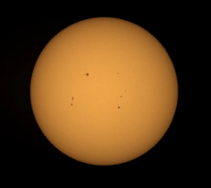 How the Sun appears through a telescope with dark spots visible. Image credit: Telescopes Plus