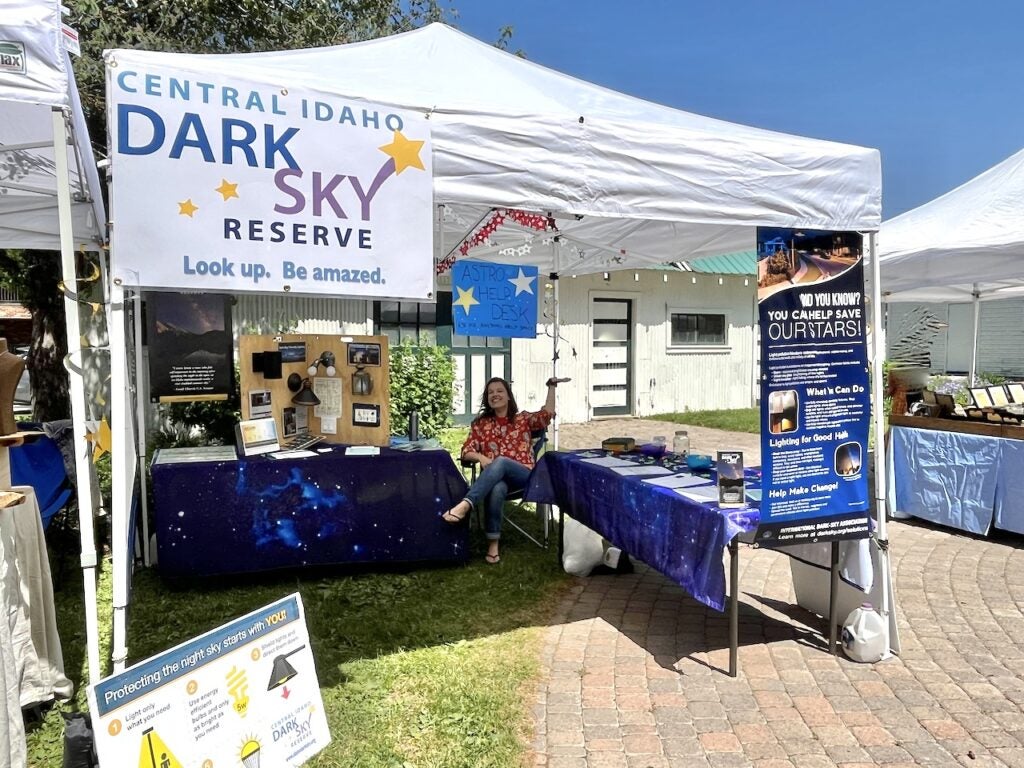 Dr. Lindsay DeMarchi hosting a booth at a farmers market.