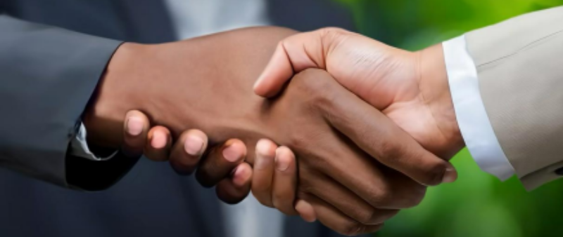 close up of two figures shaking hands