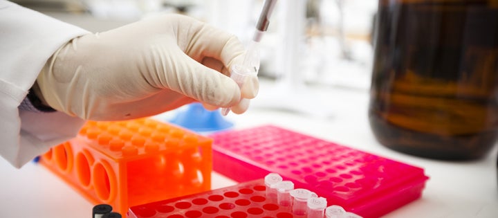 researcher filling pipette 