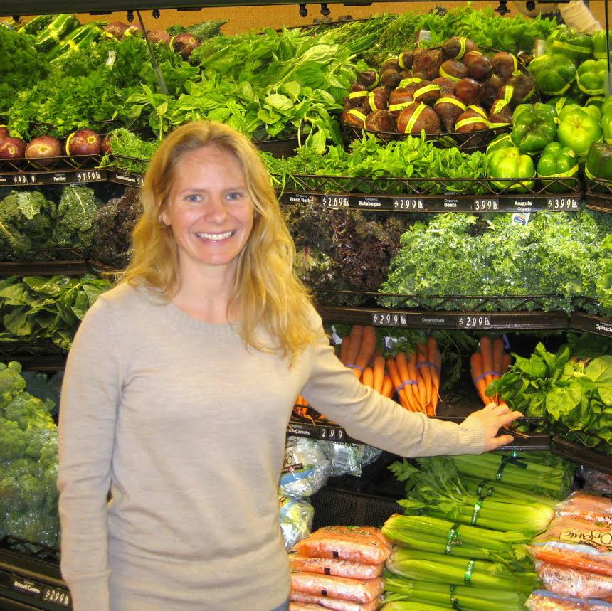 Cynthia standing in a produce aisle