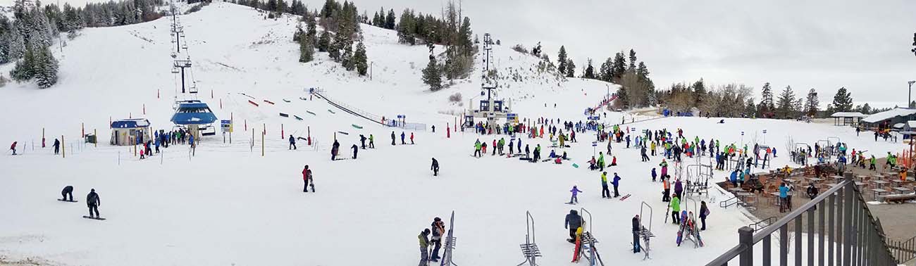 Skiers on snow at the base of the skilift