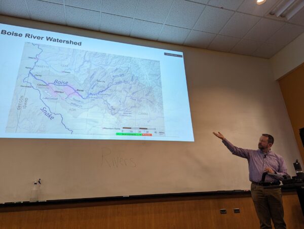 Photo of Brandon Hobbs, a civil engineer from HDR, lecturing in front of a projector image.