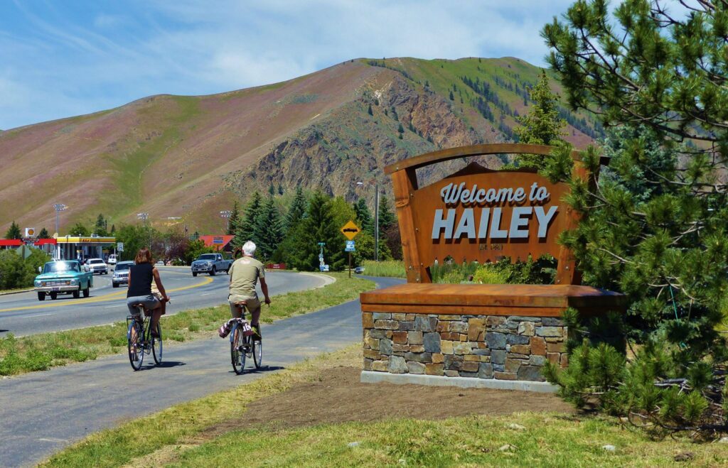City of Hailey welcome sign with cyclists passing by
